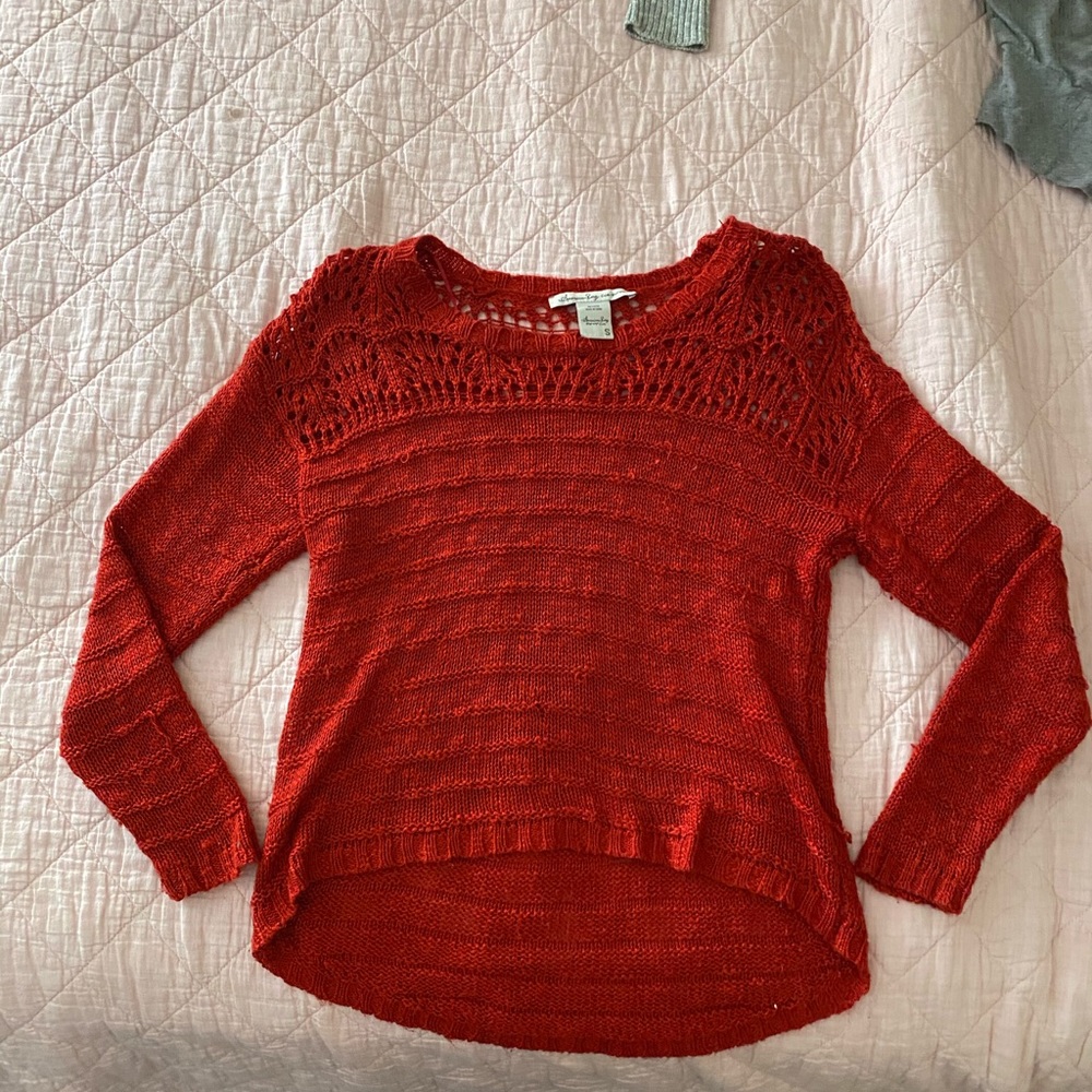 Thinly knitted red sweater